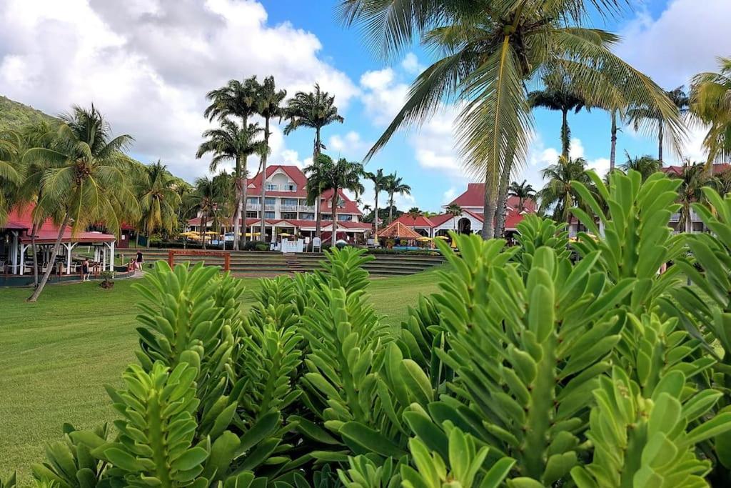 a view of a resort with palm trees and houses at Studio &quot;Prestige&quot; Sainte Luce in Sainte-Luce