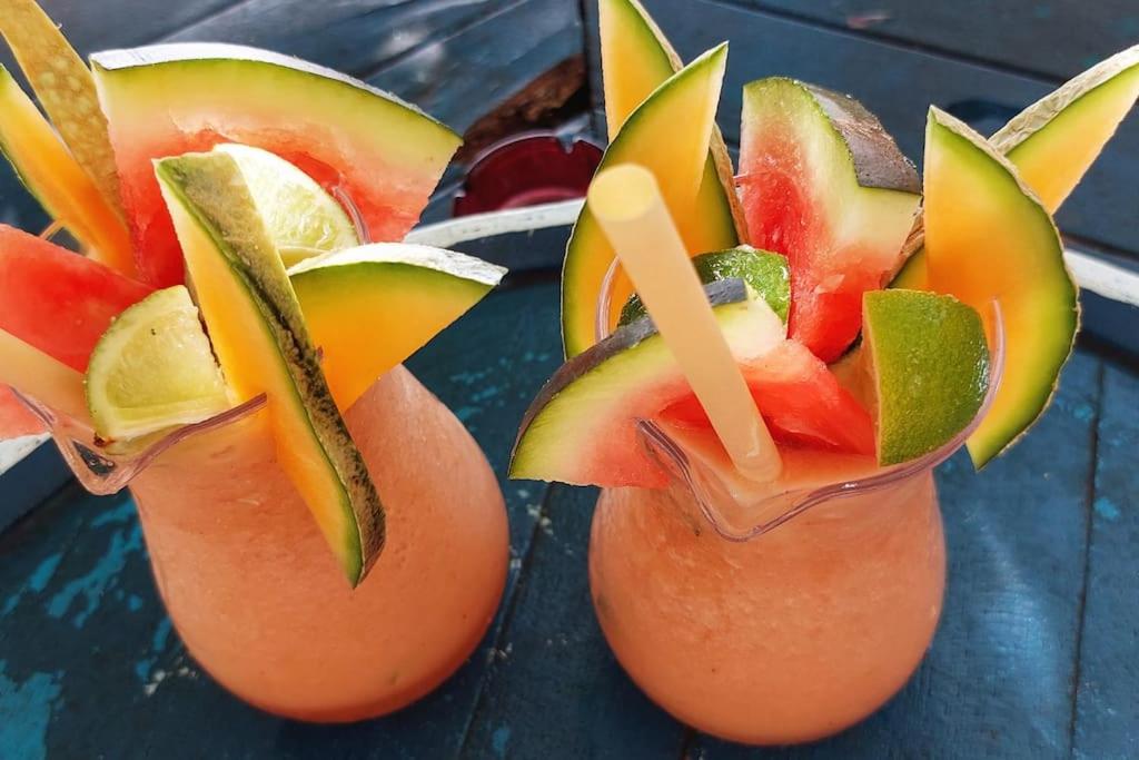 two glasses filled with fruit on top of a table at Studio &quot;Prestige&quot; Sainte Luce in Sainte-Luce