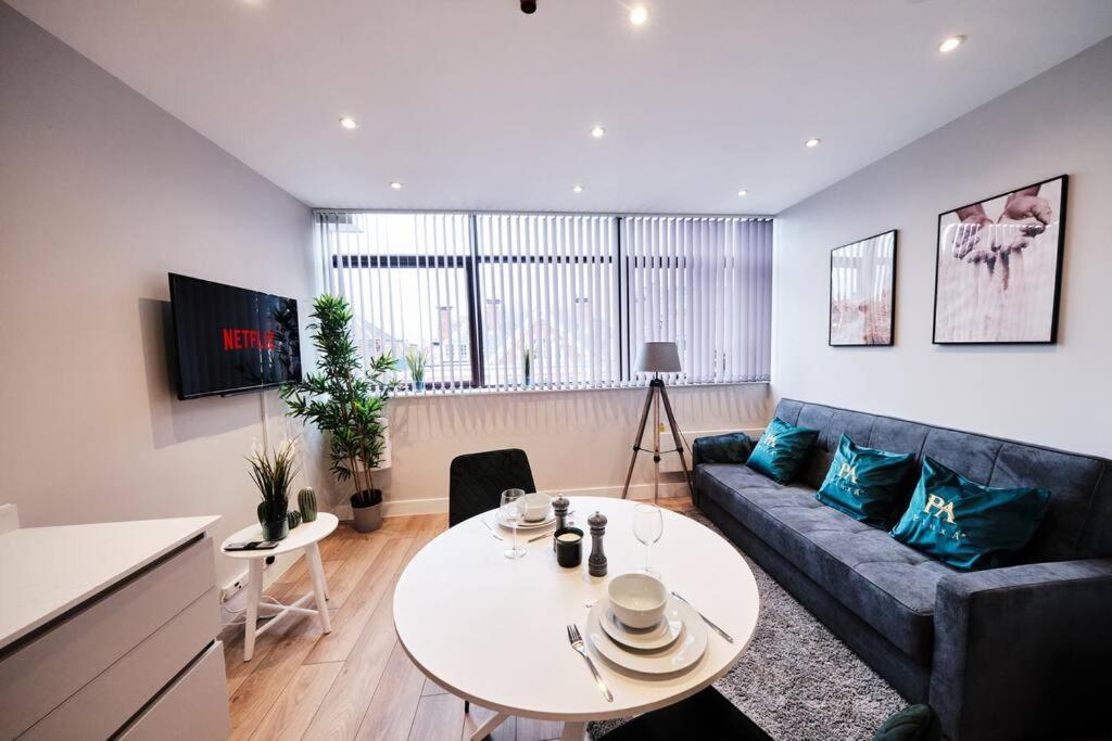 a living room with a couch and a table at Pluxa Jade - Prime Harrow, Work Desk & WiFi in Harrow