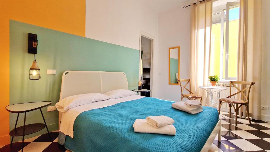 a bedroom with a bed with two towels on it at Onda su Onda in La Spezia