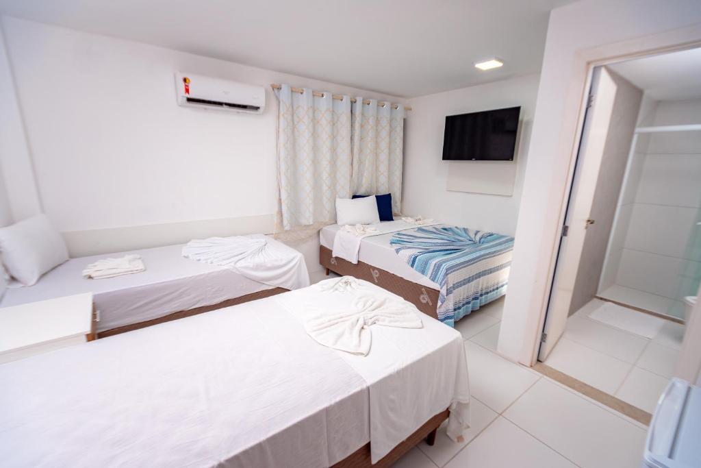 Postel nebo postele na pokoji v ubytování Brisa do Mar Praia Hotel