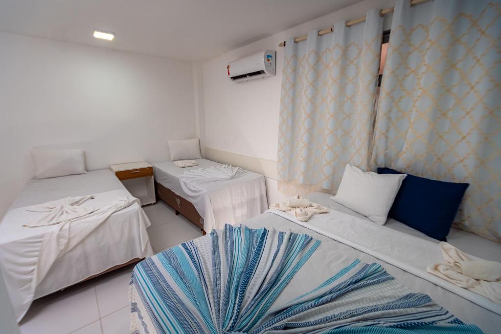 Postel nebo postele na pokoji v ubytování Brisa do Mar Praia Hotel
