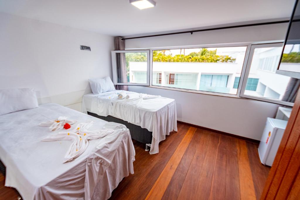 Postel nebo postele na pokoji v ubytování Brisa do Mar Praia Hotel