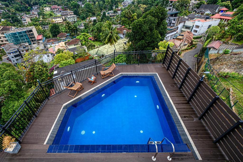 a swimming pool on a balcony with a view of a city at Queens mount Ridge in Kandy