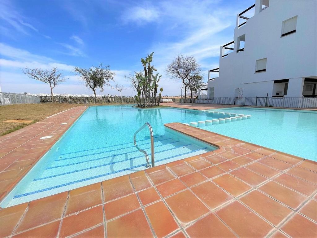une piscine vide en face d'un bâtiment dans l'établissement Appealing holiday home in Roldan with garden, à Roldán