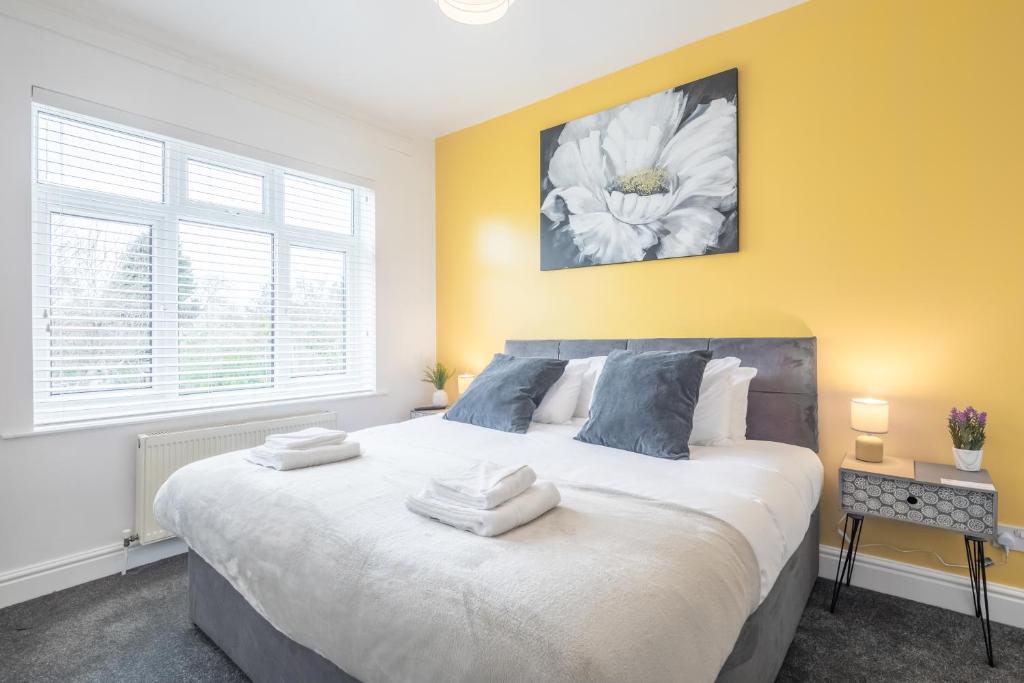 a bedroom with a large bed with towels on it at Cambridge Home Suite 5 in Cambridge