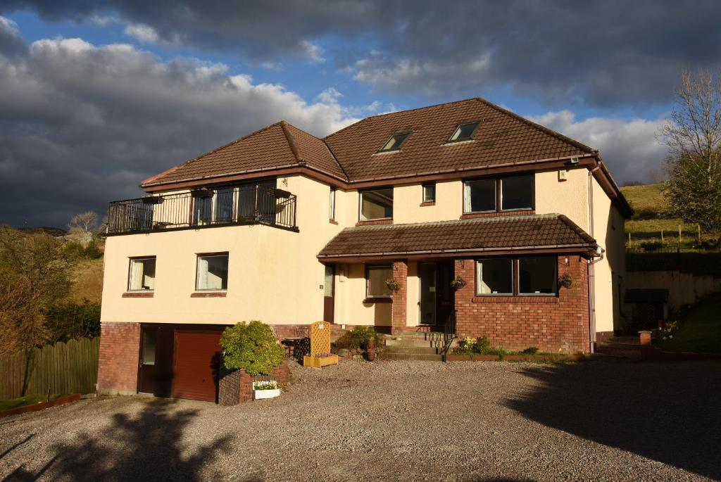 a large white house with a brown roof at Balcarres Self Catering in Fort William