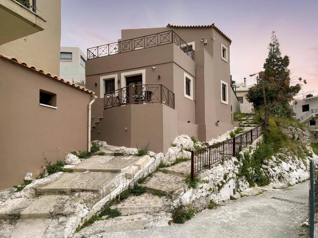 a house with stairs leading up to it at La Casa Di Manou in Platanias