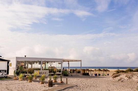 a pavilion on a beach with the ocean in the background at LXR Waikiki Beach Front 3Hab. Tarifa in Tarifa