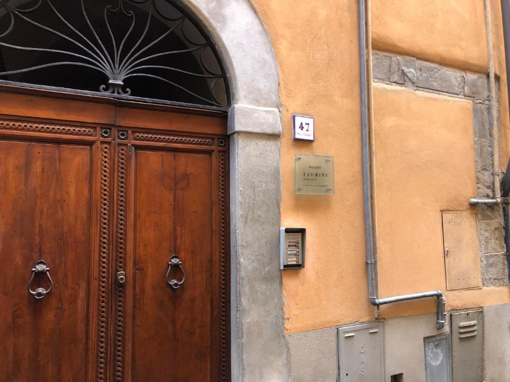 a large wooden door on the side of a building at IL SICOMORO in Sansepolcro