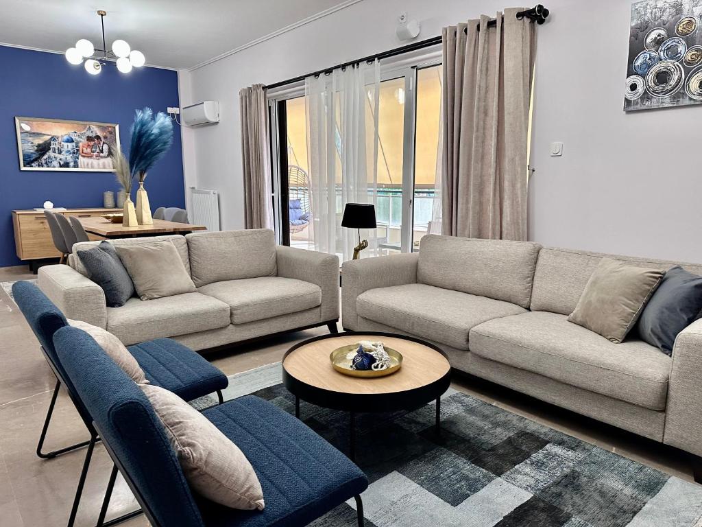a living room with two couches and a table at Elaia Luxury Selections Sapphire in Athens