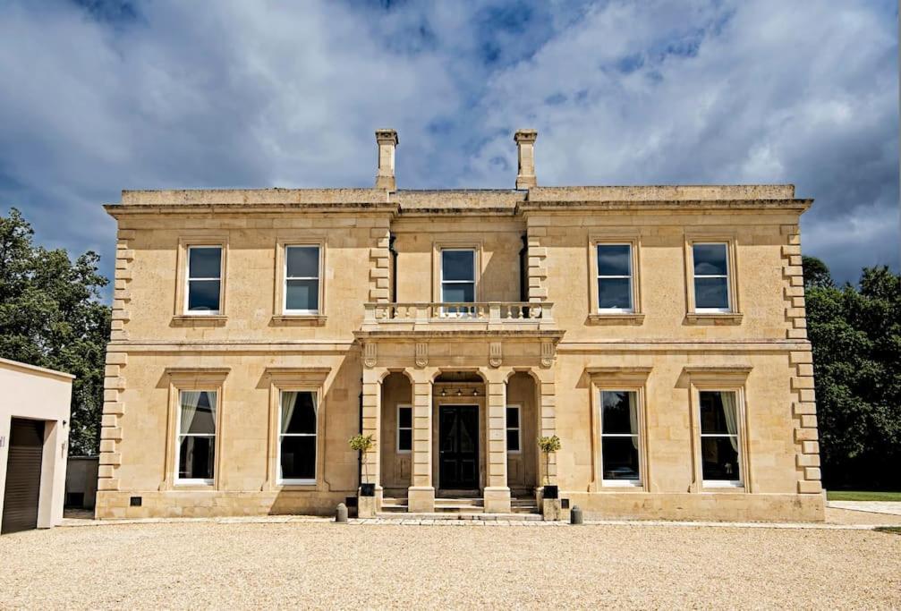 a large stone house with a large front yard at 6 Bedroom Luxury Manor House in Newbury