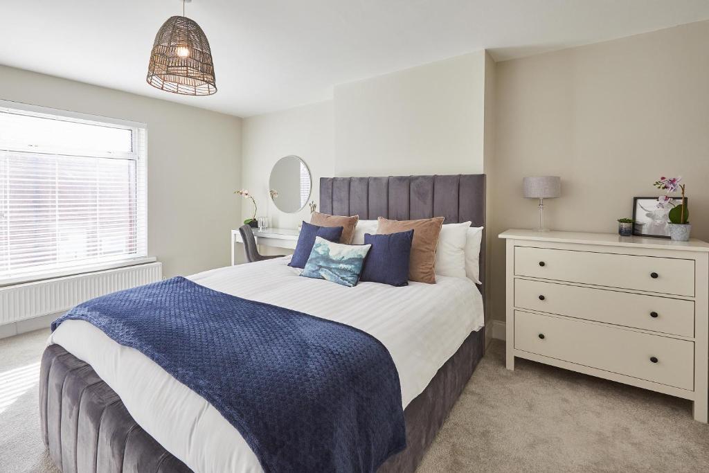 a bedroom with a large bed and a dresser at Host & Stay - No.8 in Witton Gilbert