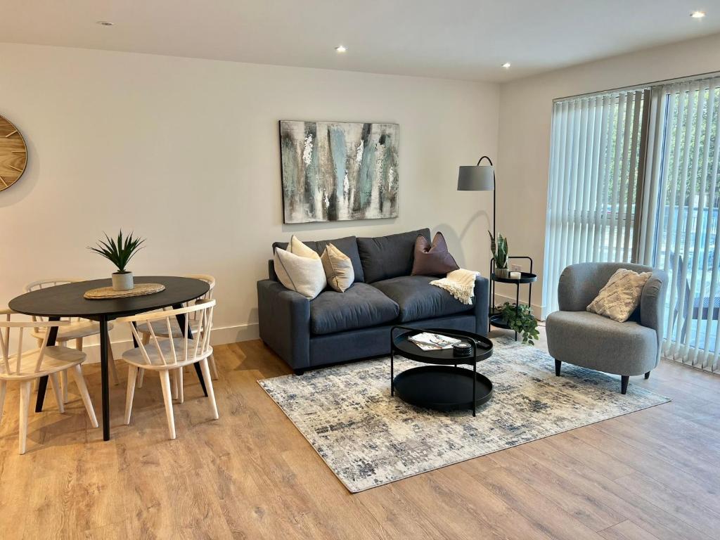 a living room with a couch and a table at 45 Teesra House in Plymouth