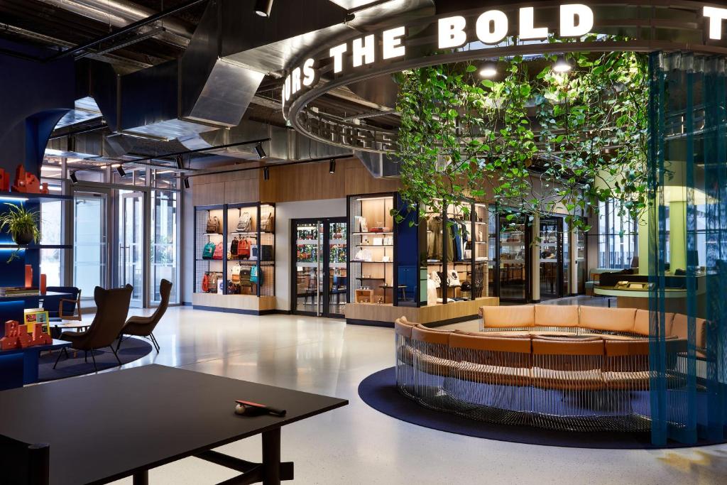 a store lobby with a couch and a sign that reads off the bold at The Social Hub Toulouse in Toulouse