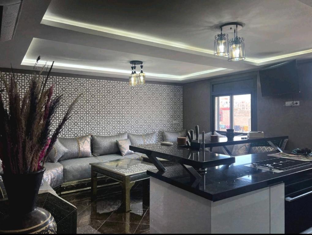een woonkamer met een bank en een tafel bij Les jardins berbères d'Agadir in Agadir