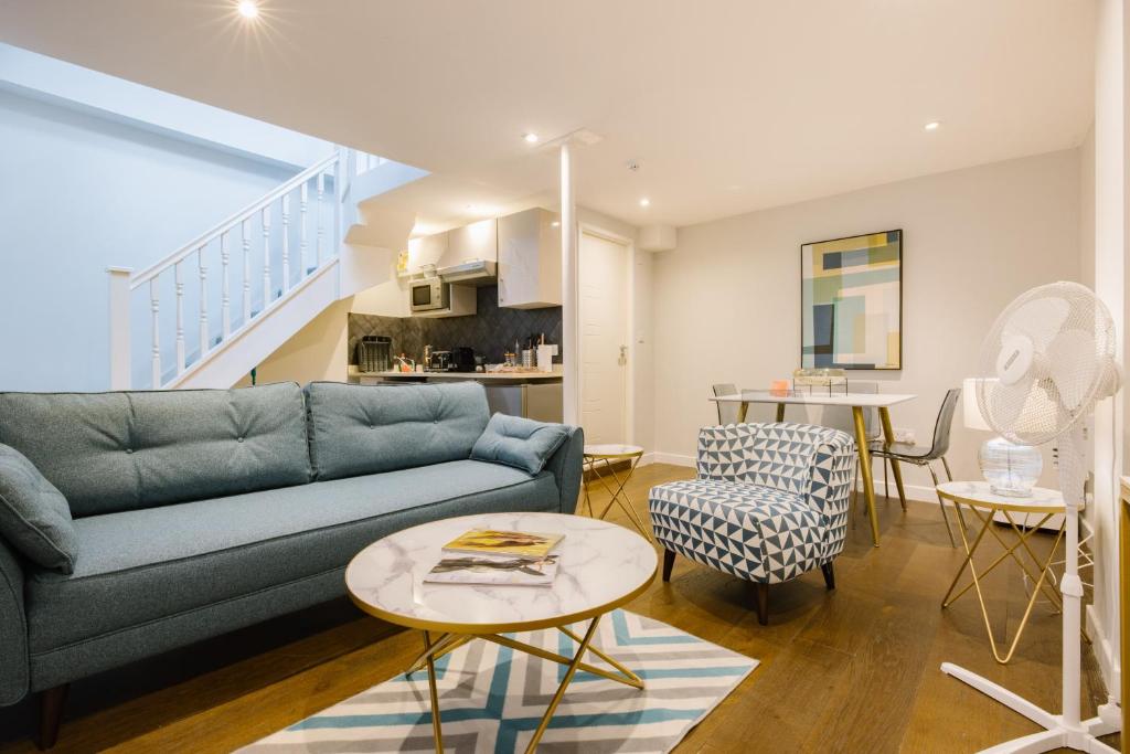 a living room with a couch and a table at CitySpace Leicester Square in London