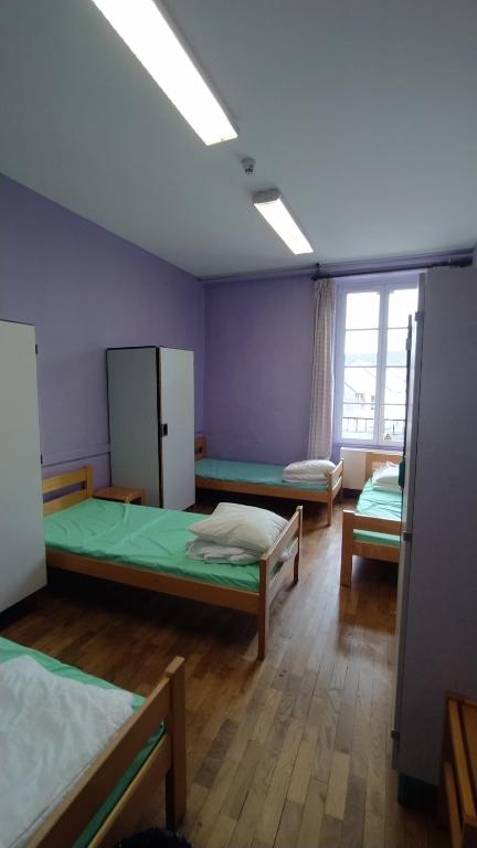 Postel nebo postele na pokoji v ubytování Logis des Grands Chapeaux