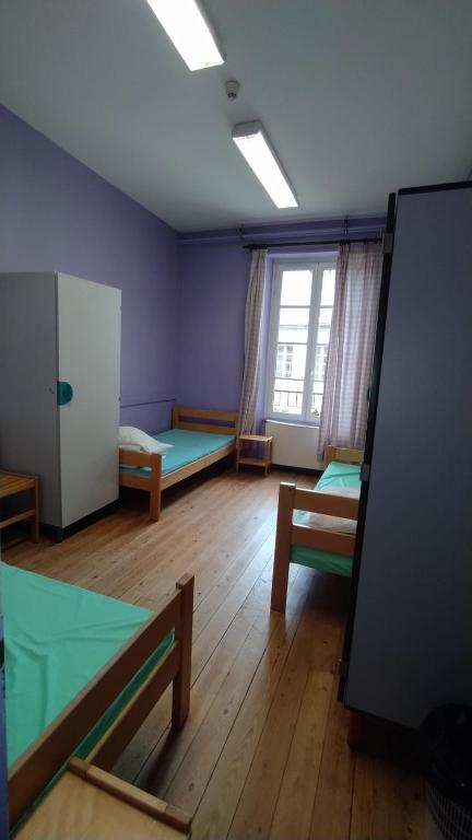 Postel nebo postele na pokoji v ubytování Logis des Grands Chapeaux
