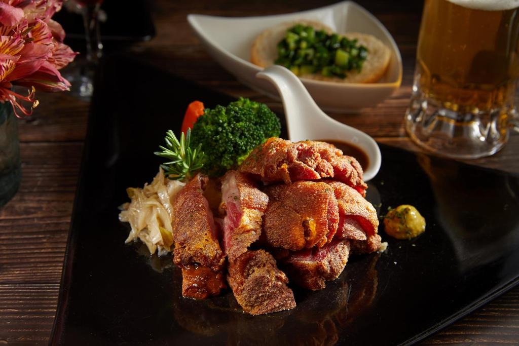 a black plate with food on a table at Ming Ging Farm in Ren&#39;ai