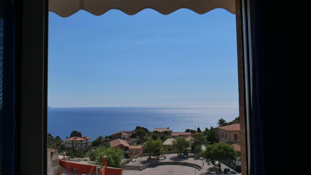 a view of the ocean from a window at Appartamento vista mare Poseidonia in Nebida
