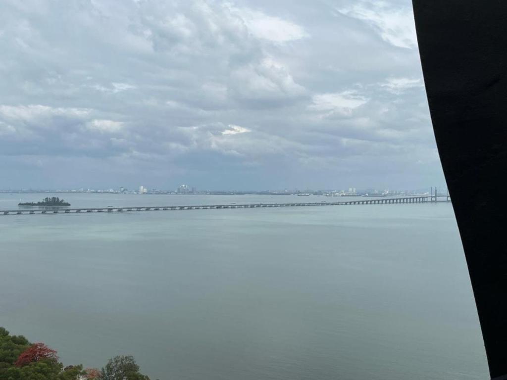 a view of a large body of water with a bridge at Good Seaview Condo, near Queensbay in Bayan Lepas