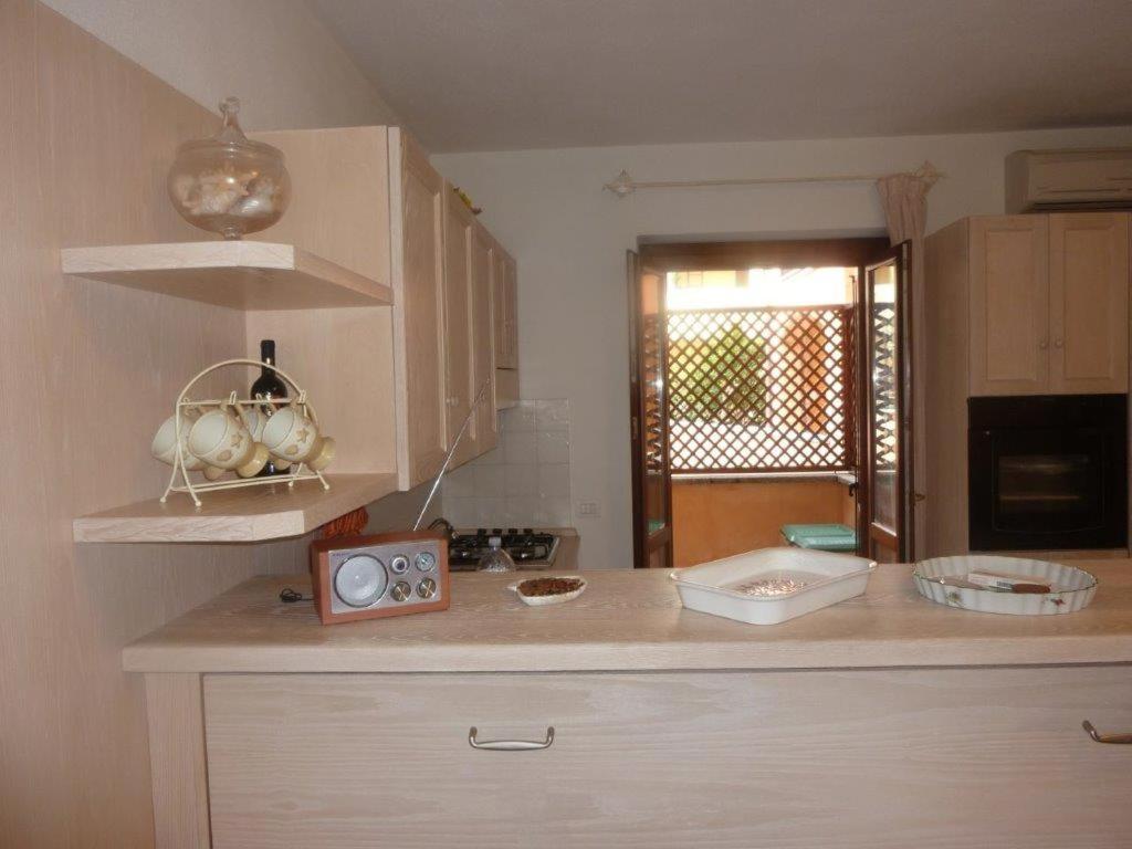 a kitchen with a counter with a clock on it at Ampio monolocale in Golfo Aranci