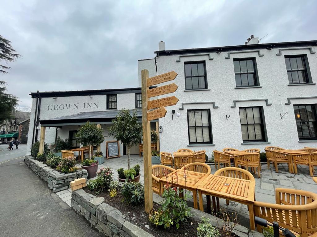 a group of tables and chairs in front of a building at The Crown Inn in Coniston