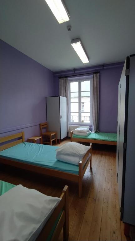 Postel nebo postele na pokoji v ubytování Logis des Grands Chapeaux