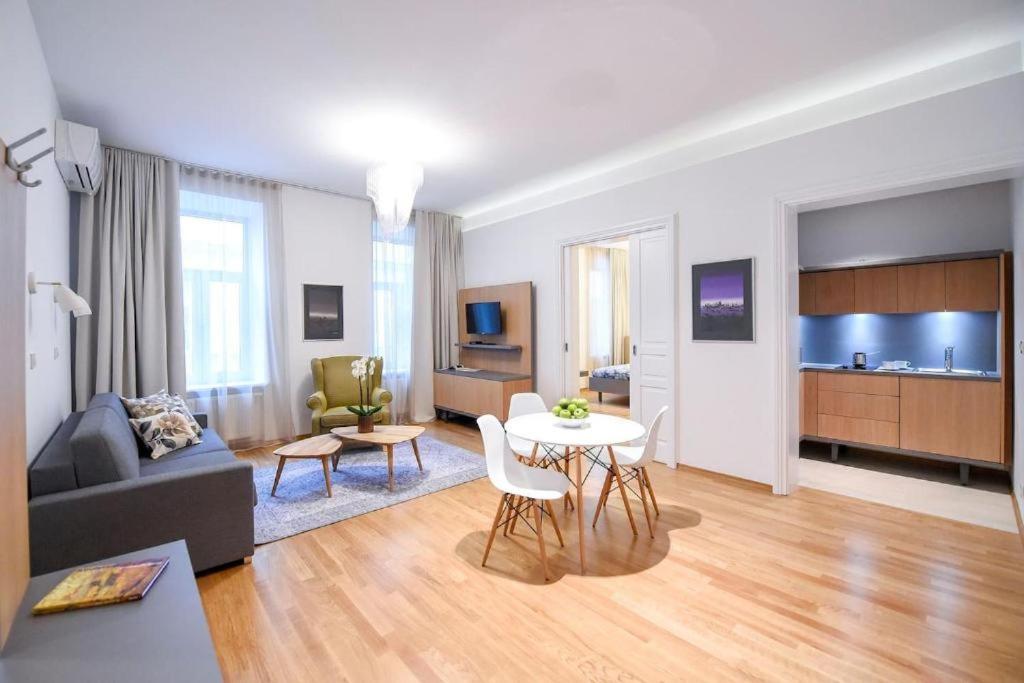 a living room with a couch and a table at City Centre Chic Apartment Ljubljana 2/4 in Ljubljana