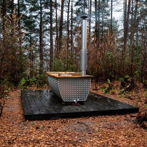 a boat sitting on a black board in the woods at Number 4 Steading Cottage in Banchory