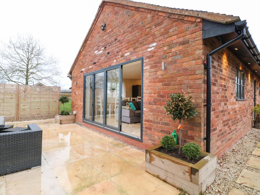 a brick house with a large glass window at Walnut View in Rugeley