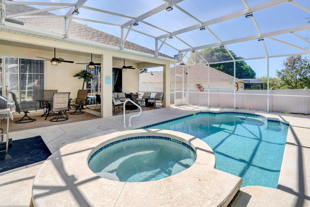a swimming pool with a pergola on a house at Stunning Minneola Home with Private Pool and Yard! in Minneola