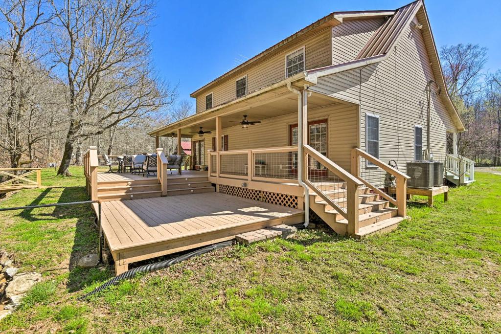 ein Haus mit einer großen Terrasse auf der Vorderseite in der Unterkunft Remote Tennessee Home with Deck, Fireplace, and Creek! in Lyles