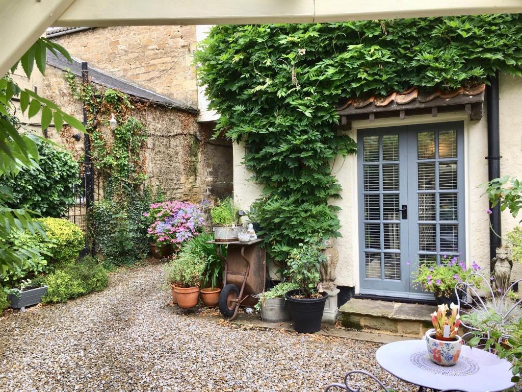 a house with a bunch of plants on the side of it at Garden Cottage in Wetherby