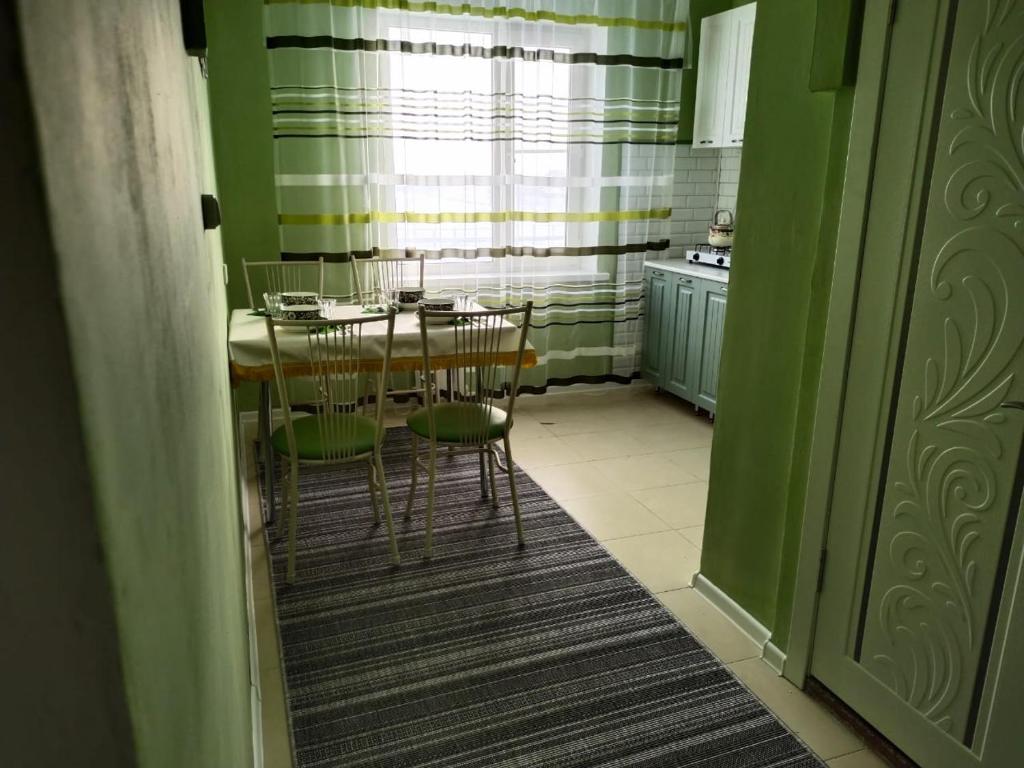 - une cuisine avec une table et des chaises dans la chambre dans l'établissement Апартаменты в Хромтау. Энглер, à Khromtaū