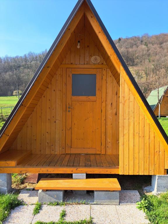 a large wooden building with a door on top at GLAMPING HIŠKe PETRIN in Tolmin