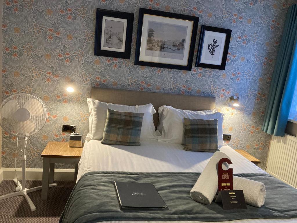 a bedroom with a bed with a laptop on it at The Station Inn Whitby in Whitby
