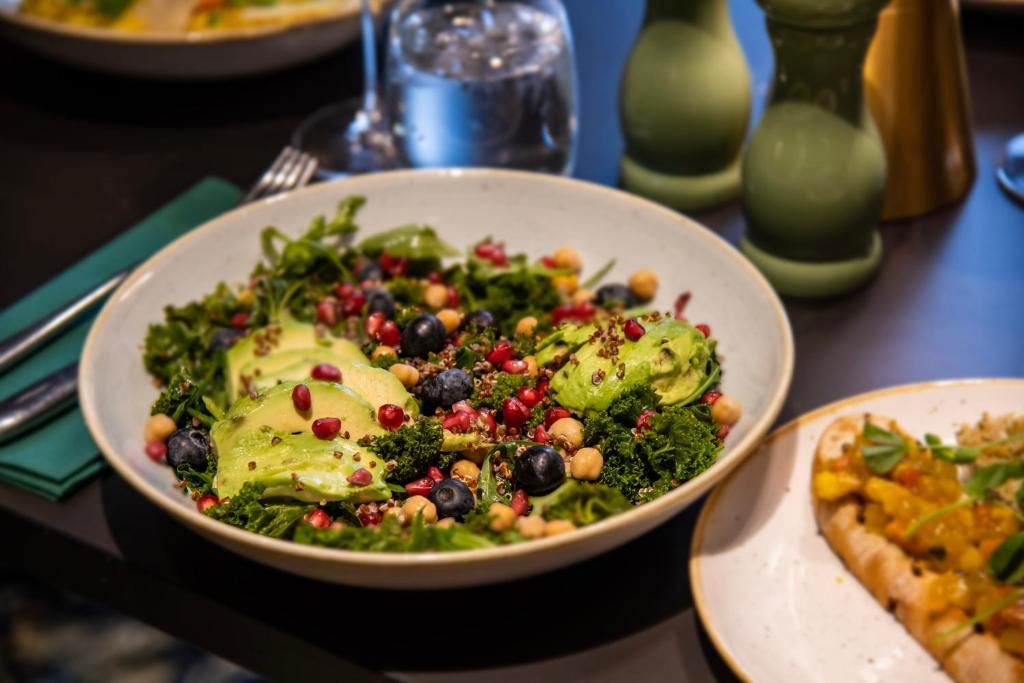 a salad in a white bowl on a table at Leonardo Royal Hotel Birmingham in Birmingham