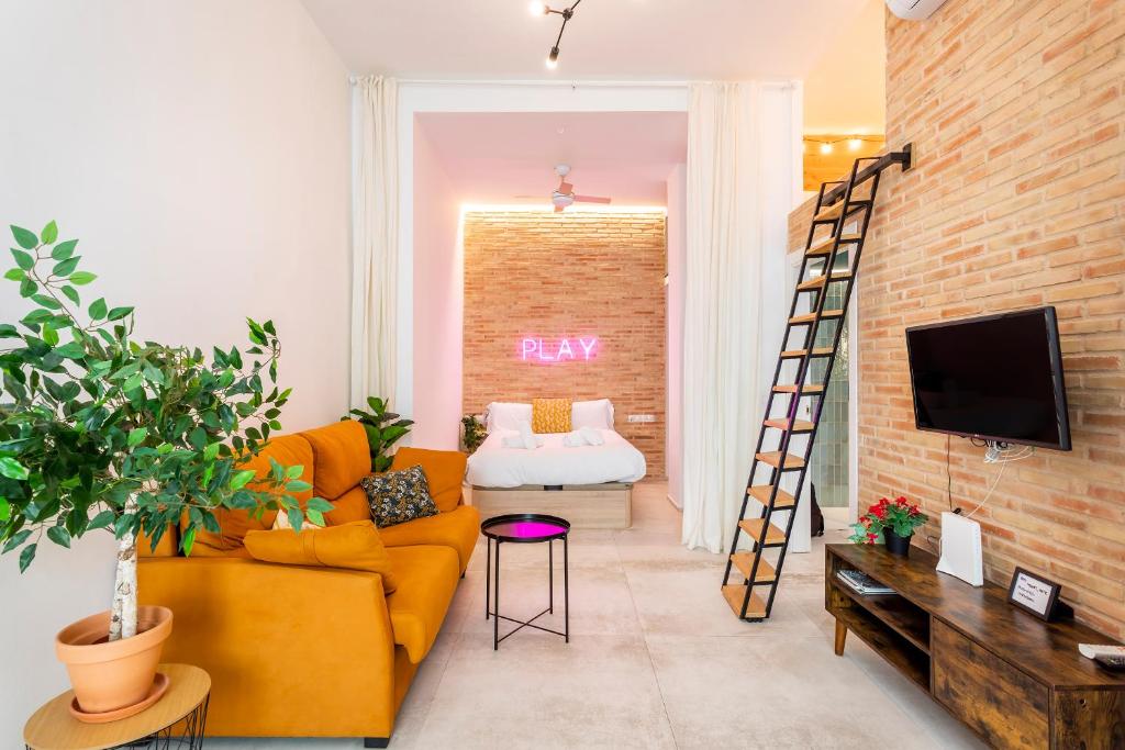 a living room with a yellow couch and a brick wall at CHARMING LOFT IN RUZAFA, SOHO b2 in Valencia