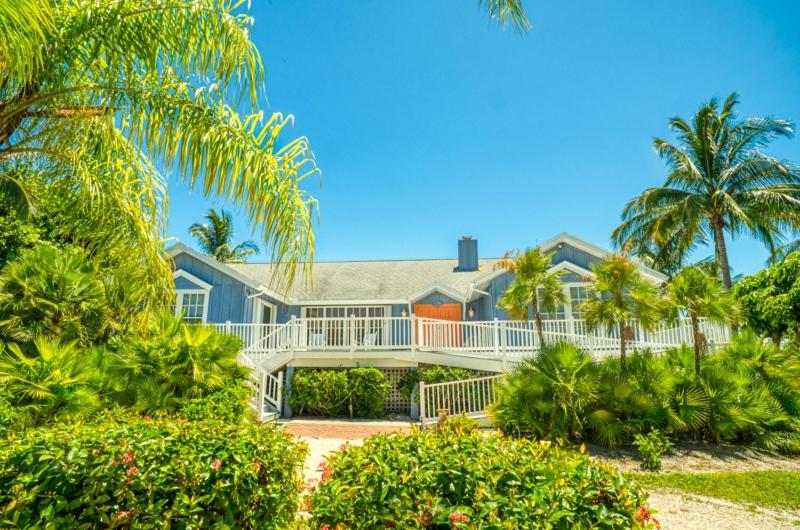 an exterior view of a house with palm trees at Baywatch Casa home in Captiva