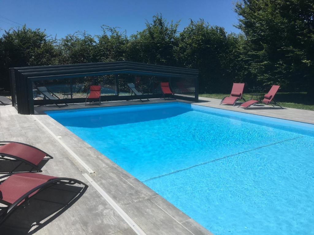 a swimming pool with chairs and a gazebo at The Originals City, Hôtel Rey du Mont Sion, Saint-Julien-en-Genevois Sud (Inter-Hotel) in Saint-Blaise