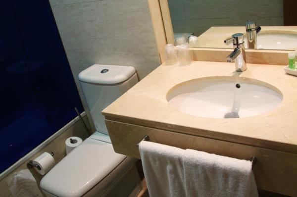 a bathroom with a sink and a toilet at Hotel Moon in A Coruña