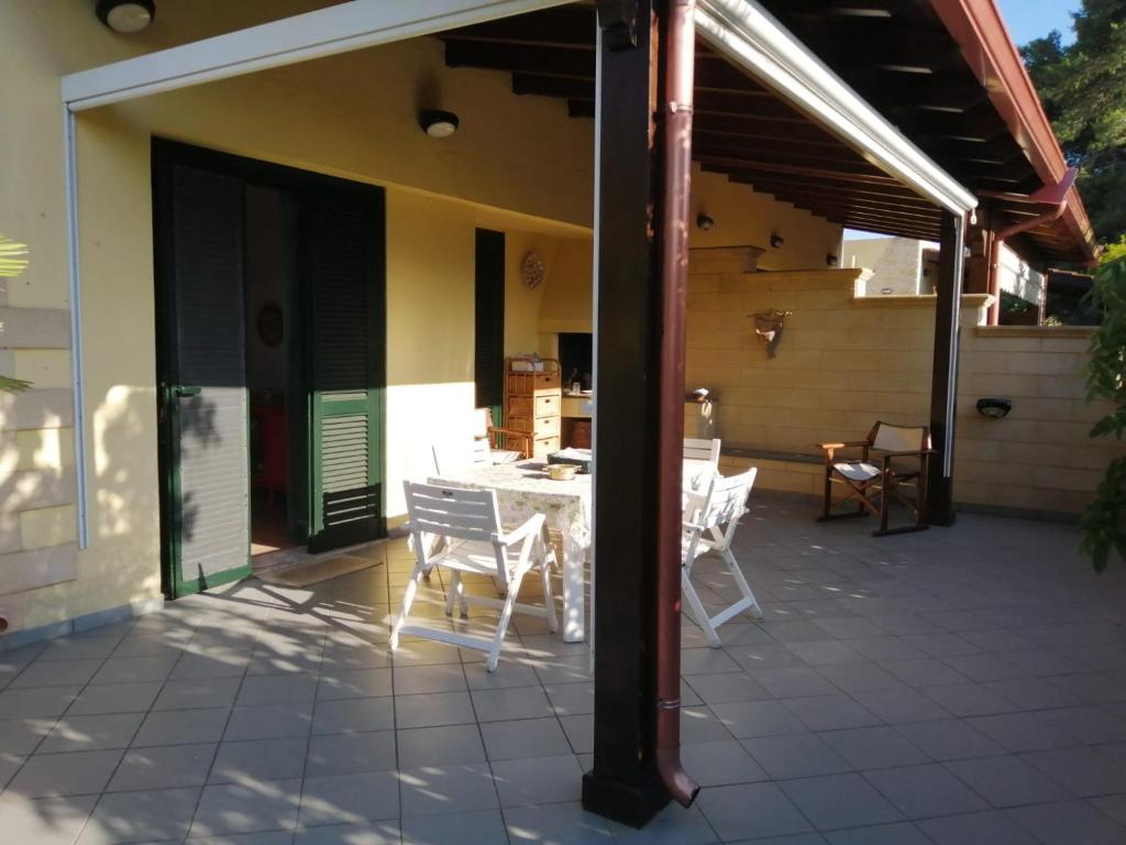 a patio with a table and chairs on a house at VILLA LORETTA in Torre dell'Orso