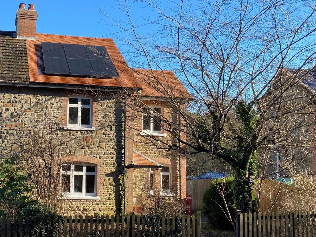 a house with solar panels on the roof at Willow Cottage in Longney