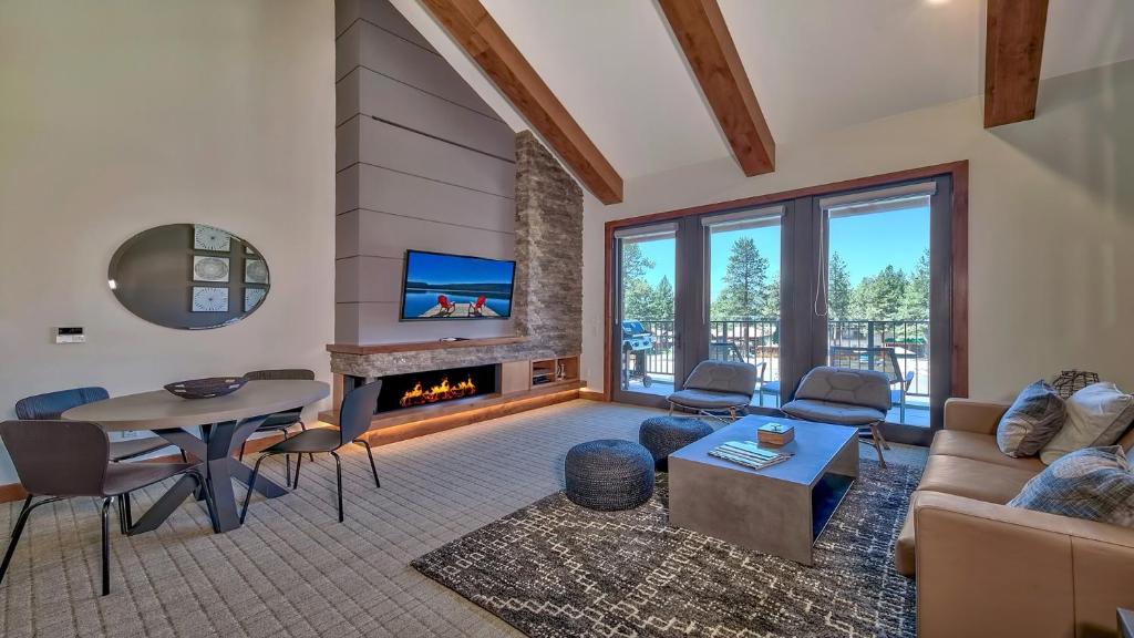 a living room with a couch and a table and a fireplace at Luxury Residence - Gondola Across The Street Condo in South Lake Tahoe