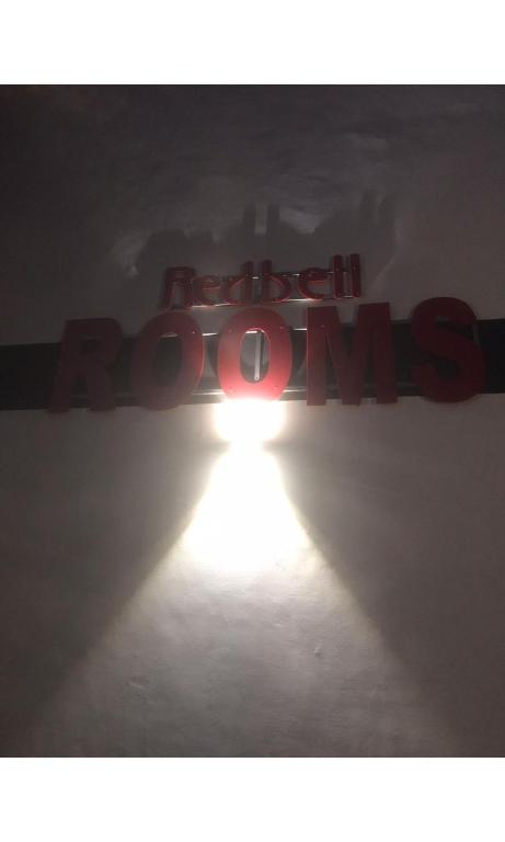 a sign with the words hated doors with a light at Redbell Inn Airport Hotel in Kondotti