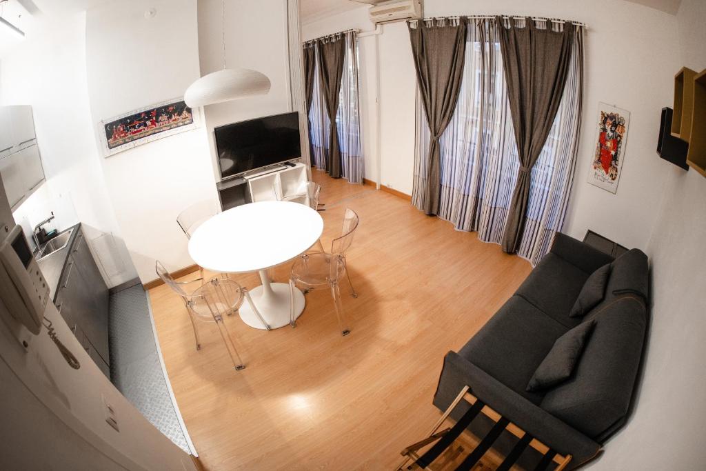 - un salon avec une table et des chaises dans l'établissement Bubi House Porta Venezia, à Milan