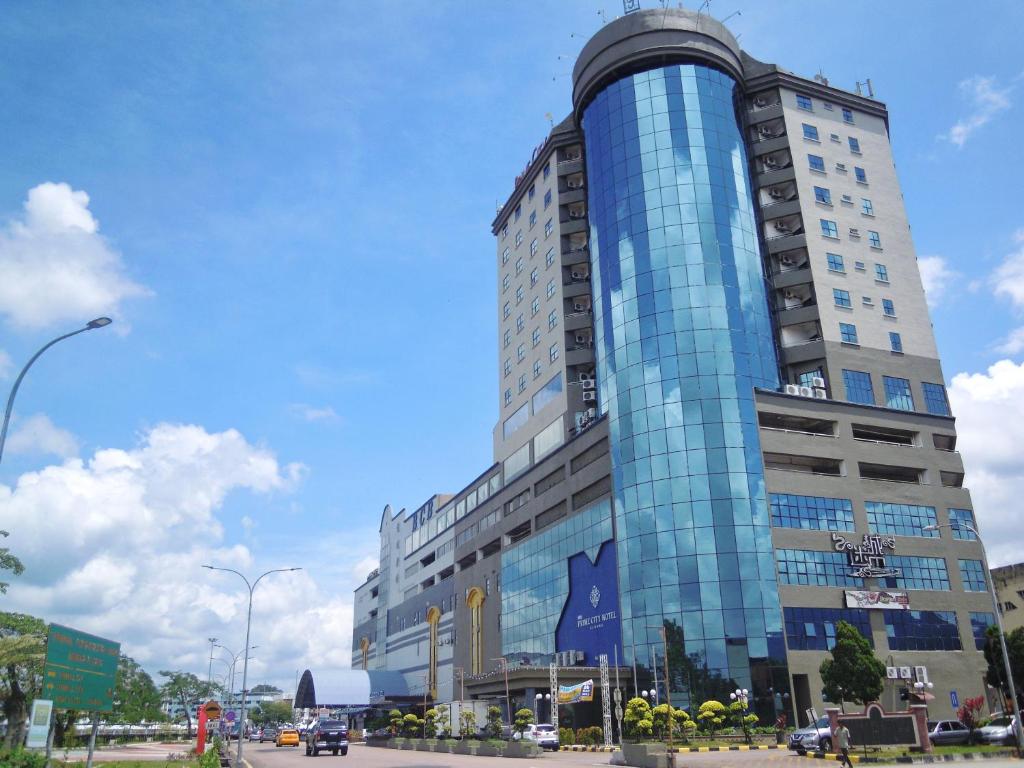 a tall building with a blue glass facade at PRIME CITY HOTEL KLUANG in Kluang