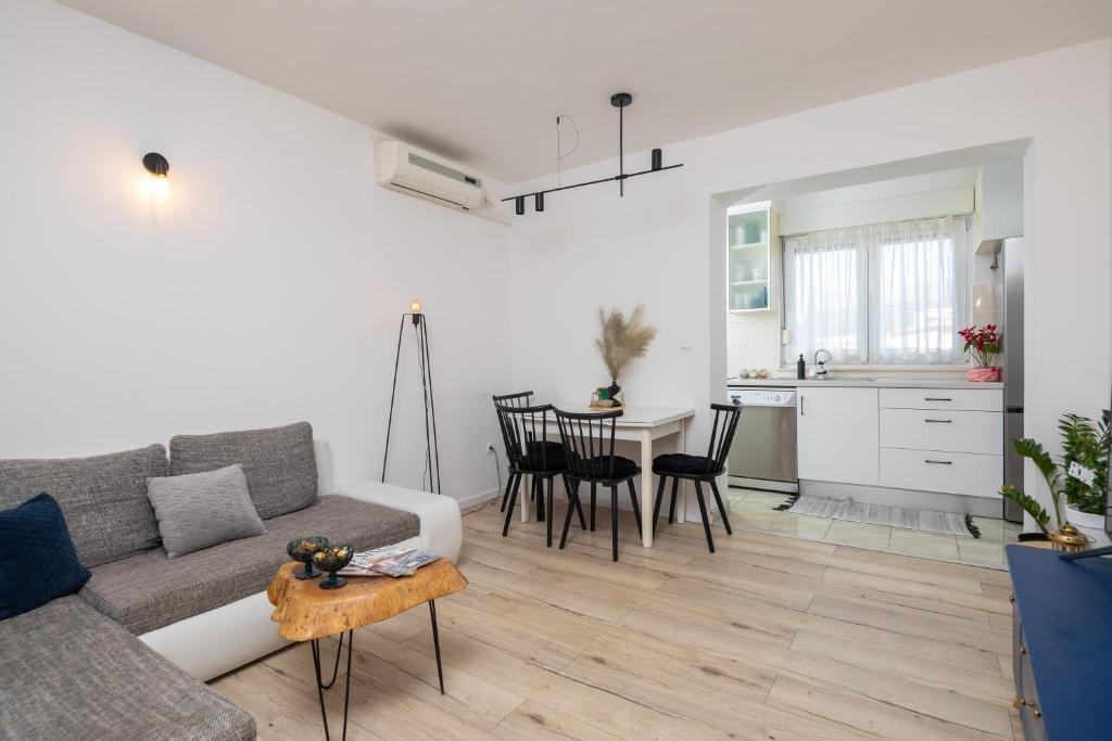 a living room with a couch and a table at Split City App - Private Parking & Terrace in Split